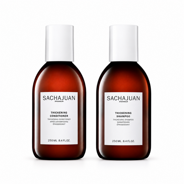 Two bottles of Sachajuan shampoo and conditioner on a white background