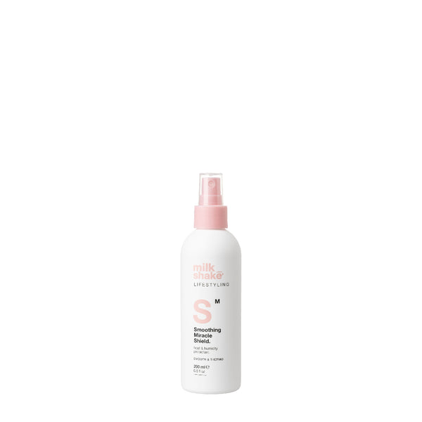 White spray bottle with pink nozzle on a white background