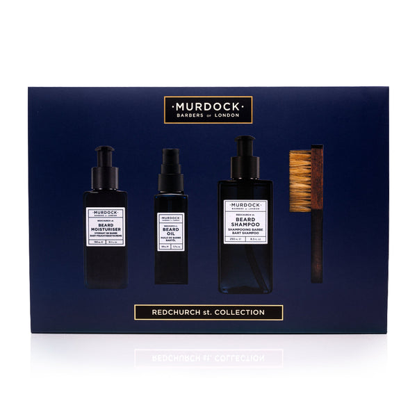 Murdock London beard care set with bottles and a brush on a blue background