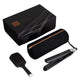 A hair styling kit on a white background, including a black flat iron, a black paddle brush, a black cylindrical carrying case with a rose gold zipper, and a black presentation box.
