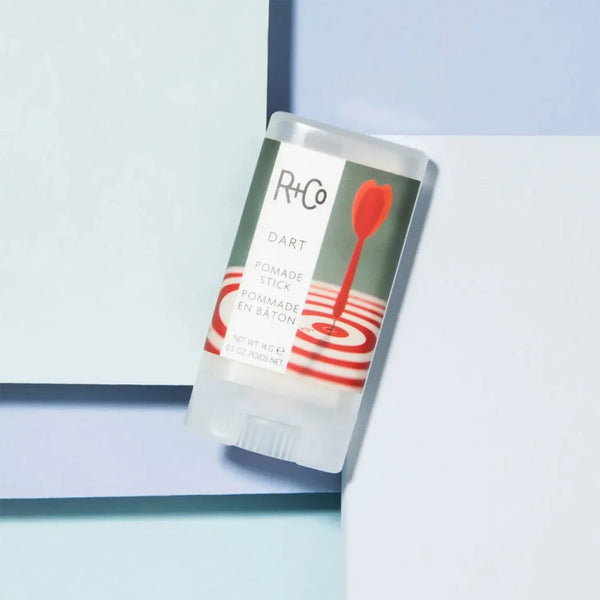 a closeup of a R+Co Dart Pomade Stick