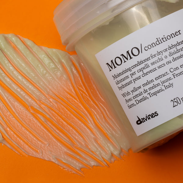 Jar of Momo conditioner with a label on an orange background
