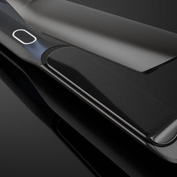 A close-up studio shot of a sleek black hair straightener with glossy metallic edges, shown open against a dark reflective background.