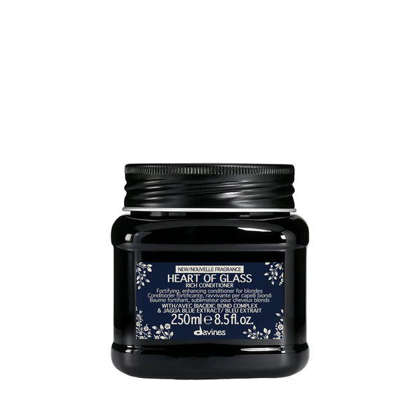 Black jar of davines 'Heart of Glass' conditioner on a white background