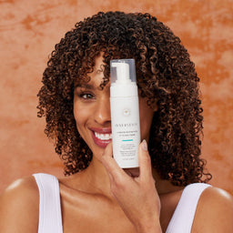 a women with the product close to her face