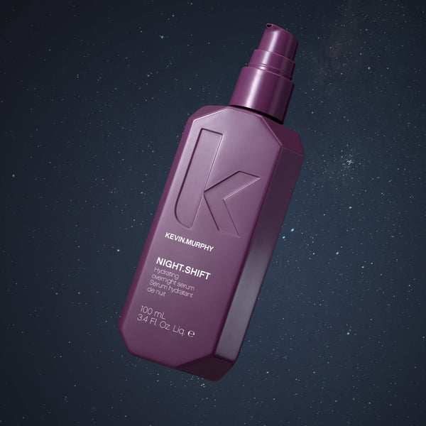Purple bottle of Kevin Murphy hair product on a dark background