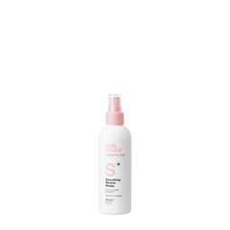 White spray bottle with pink nozzle on a white background