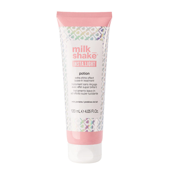 A squeeze tube of Milk Shake Insta.Light Potion hair shine effect treatment, featuring a pink cap and base with a white center and a subtle iridescent geometric pattern.