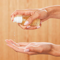 Innersense Hair Renew Scalp Oil being poured into a hand