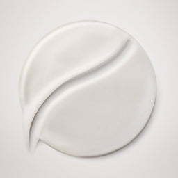 White cream smear on a light gray background