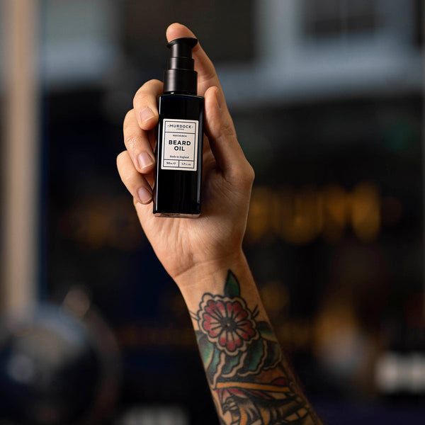 Murdock London Beard Oil 50ml held into the air