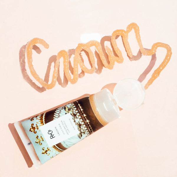 a tube of R+Co Crown Scalp Scrub with Crown written in scrub