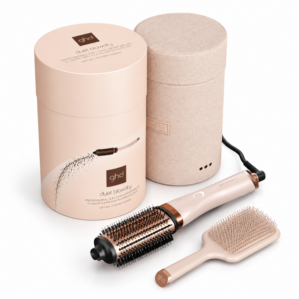 GHD dual beauty styling tool set with a round hot air brush, a flat brush, a power cord, and two cylindrical packaging cases on a white background.